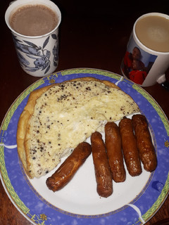 A picture of Plain omelette and deep fried sausages.