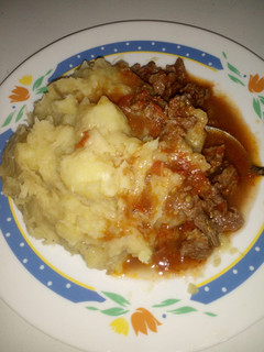 A picture of Mashed bananas with beef stew.