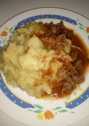 A picture of Mashed bananas with beef stew.