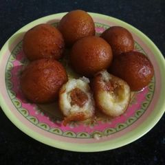 A picture of Gulab jamun with dates & coconut balls.
