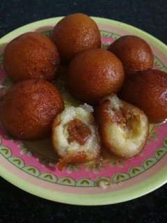 A picture of Gulab jamun with dates & coconut balls.