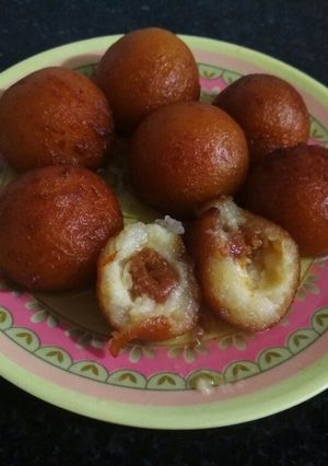 A picture of Gulab jamun with dates & coconut balls.