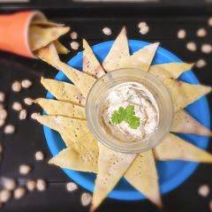 A picture of Baked spiced chickpeas nachos with hung curd dip.