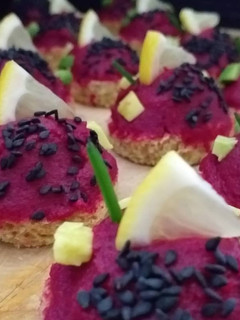 Una foto de Canapés veganos con hummus de beterraga