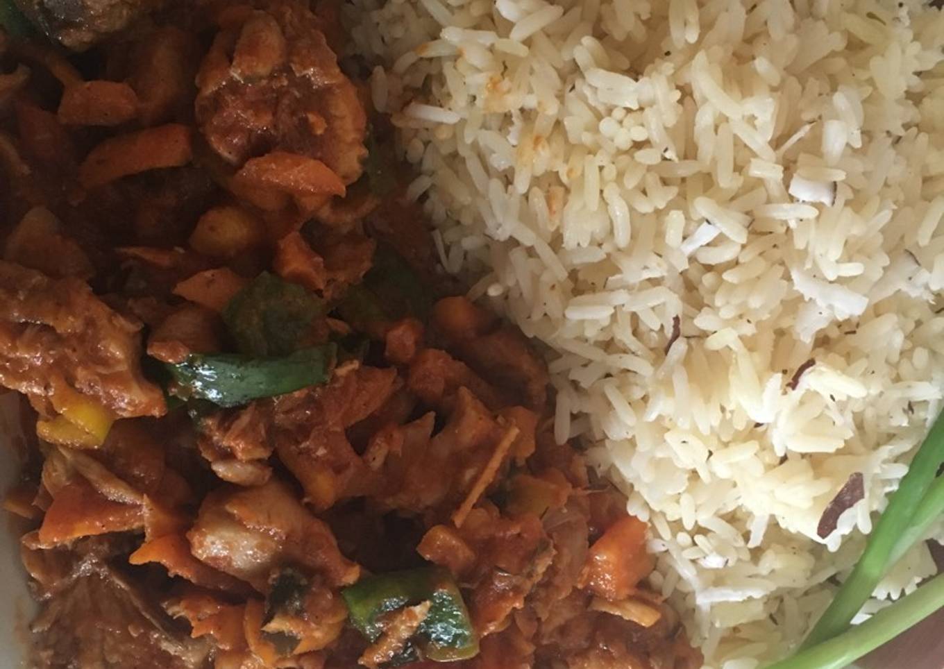 White coconut rice paired with carrot sauce and chicken