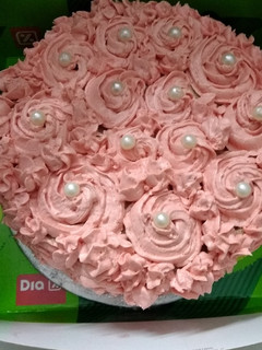A picture of Chocolate cake with strawberry rosette frosting.