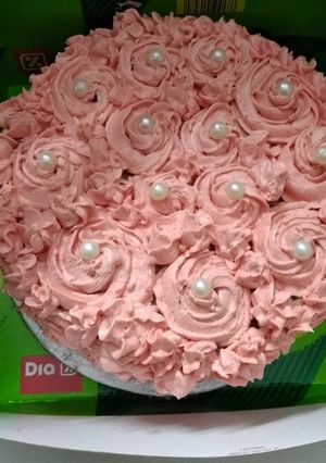 A picture of Chocolate cake with strawberry rosette frosting.