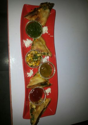 A picture of Corn spinach sandwich with green chutney.