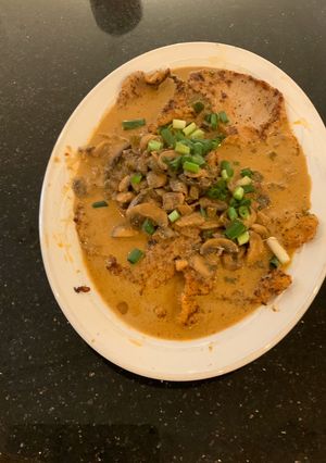A picture of Veal with Mushroom Sauce.