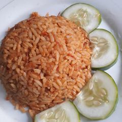 A picture of Jollof with cucumber.
