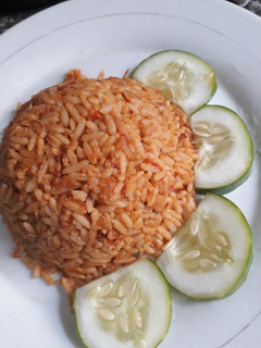 A picture of Jollof with cucumber.