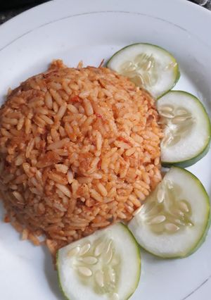 A picture of Jollof with cucumber.