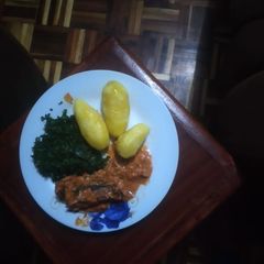 A picture of Fish fillet coconut served with deep fried potatoes.