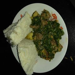 A picture of Ugali and beef with khale / spinach.