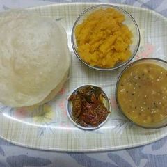 A picture of Halwa Pori Tarkari with Achar.