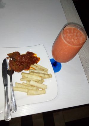 A picture of Fried yam and pepper goat meat + water melon smoothie.