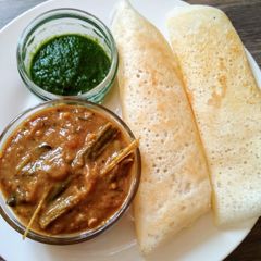 Dosa with sambar and green chutney A picture of Dosa with sambar and green chutney.