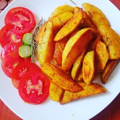 A picture of Rosemary baked potato wedges.