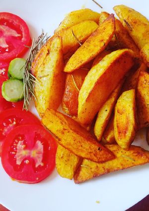 A picture of Rosemary baked potato wedges.