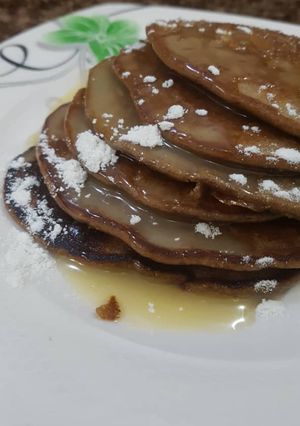 A picture of Chocolate pancake with condensed milk topping.