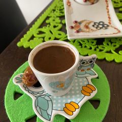 A picture of Turkish coffee with dried dates in the morning.