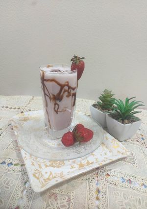 A picture of Strawberry shake with chocolate sauce.