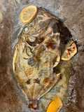 Baked John Dory fish with lemon, garlic and rosemary
