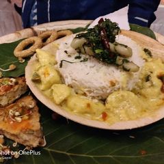 A picture of Dahi pakoda curry with rice and stuffed sprouts paratha.