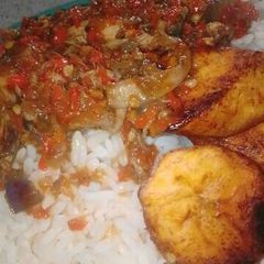 A picture of Rice and plantain with pepper sauce.