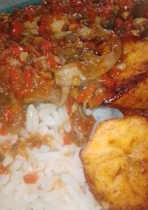 A picture of Rice and plantain with pepper sauce.