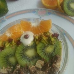 A picture of A fancy fruit&yogurt bowl with choco-pistachio.