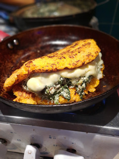 Una foto de Omelette anaranjado relleno de verde y blanco 😋