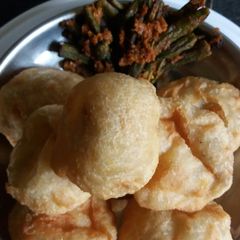 A picture of Lentil kachori with spicy lady fingers.