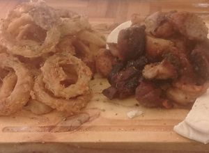 Una foto de Fried porque and  whole onion rings by luis