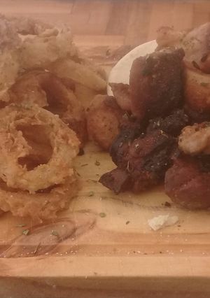 Una foto de Fried porque and  whole onion rings by luis