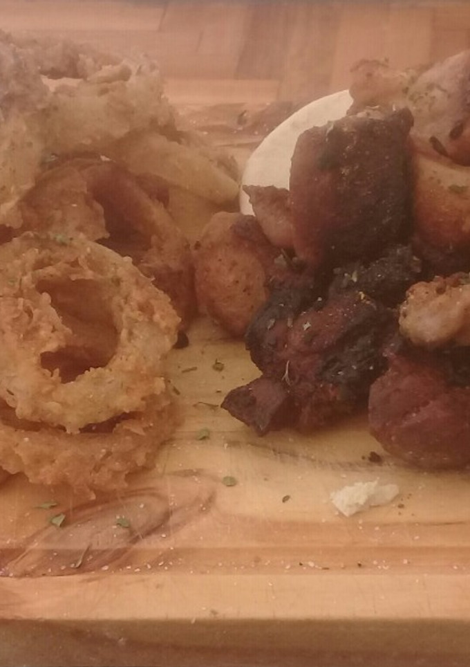 Una foto de Fried porque and  whole onion rings by luis