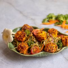 A picture of Pea noodle Stir fried with crispy mustard and turmeric tofu.