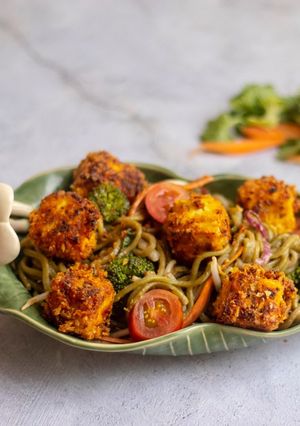 A picture of Pea noodle Stir fried with crispy mustard and turmeric tofu.