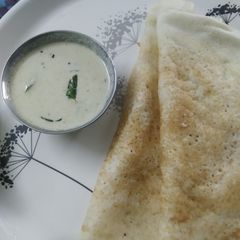 A picture of Coconut chutney with Dosa.
