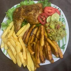 A picture of Juicy roasted chicken with chips & plantain and guacamole.