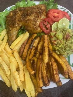 A picture of Juicy roasted chicken with chips & plantain and guacamole.