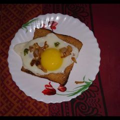 A picture of Egg half fry with toast.