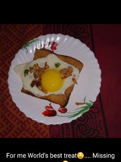 A picture of Egg half fry with toast.