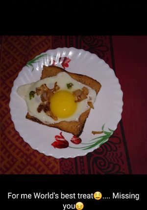 A picture of Egg half fry with toast.