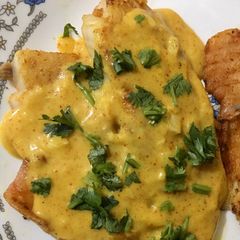 A picture of Tilapia in coconut sauce.