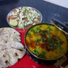 Punjabi dal tadka with salad and roti A picture of Punjabi dal tadka with salad and roti.