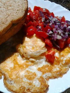 A picture of Omelette, Kachumbari and Bread.