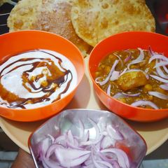 A picture of Aloo Chana Poori with dahi bhalla.