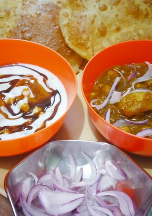 A picture of Aloo Chana Poori with dahi bhalla.