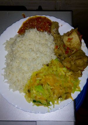 A picture of White rice with cabbage and chicken.